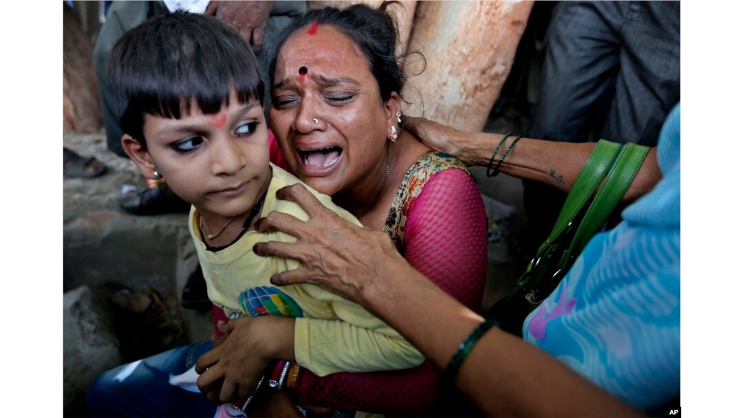 A relative of a an Indian man convicted for the 2002 Gujarat riots cries after the court announced the lengths of the sentences in Ahmadabad, India on June 17, 2016.