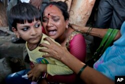 A relative of a an Indian man convicted for the 2002 Gujarat riots cries after the court announced the lengths of the sentences in Ahmadabad, India on June 17, 2016.
