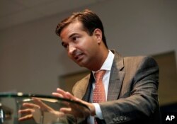 FILE - Rep. Carlos Curbelo, R-Fla., speaks during an interview in Homestead, Fla., May 29, 2018.