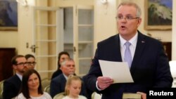 New Australian Prime Minister Scott Morrison is seen at his swearing-in ceremony as his wife Jenny looks on, in Canberra, Australia, Aug. 24, 2018.