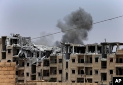 Smoke rises from a coalition airstrike on an Islamic State position, on the front line on the western side of Raqqa, northeast Syria, July 17, 2017.