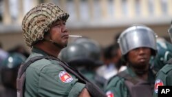 Cambodian police officers stand guard at a blockade on a main street in Phnom Penh, file photo. 