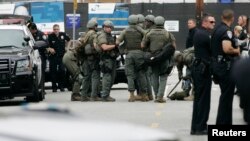Police officers gather during a search at Santa Monica College.