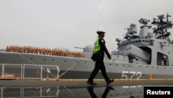 A guard passes by the Russian naval vessel Admiral Vinogradov during a port visit in Manila, Philippines, Oct. 20, 2017. 