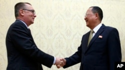 North Korean Foreign Minister Ri Yong Ho, right, and U.N. undersecretary-general for political affairs Jeffrey Feltman shake hands at the Mansudae Assembly Hall in Pyongyang, North Korea, Dec. 7, 2017. The senior United Nations official is on a four-day v