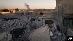 An Iraqi soldier stands atop a destroyed house in a neighborhood recently retaken by Iraqi security forces during fighting against Islamic State militants in west Mosul, Iraq, June 25, 2017.