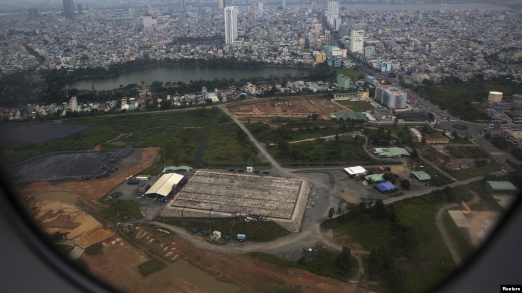 FILE - The cleaning operation of the area that was used for storing Agent Orange is seen from a plane taking off from Danang international airport.