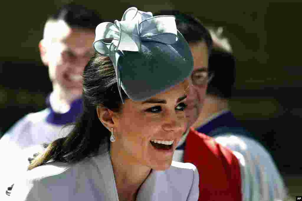 Britain's Kate, the Duchess of Cambridge, meets members of the cathedral choir following an Easter Sunday service at St. Andrews Cathedral in Sydney, Sunday, April 20, 2014. Kate and her husband Prince William, along with their son Prince George, are on a