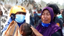 A woman weeps after her home was destroyed by the eruption of Mount Semeru in Lumajang district, East Java province, Indonesia, Dec. 7, 2021.