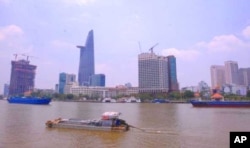 A view over the Saigon river next to Ho Chi Minh city’s financial district … An expert in illegal wildlife trafficking says many of the people involved in the illicit trade in rhino horn are from this and other Vietnamese cities.
