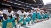 US Pro Football Players Kneel During National Anthem