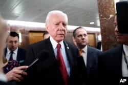 FILE - Senate Health, Education, Labor and Pensions Committee member Sen. Orrin Hatch, center, speaks on Capitol Hill in Washington, Jan. 31, 2017.