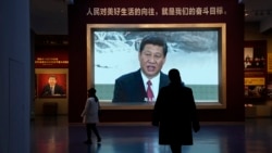 Chinese President Xi Jinping is seen on screen near the slogan "The people's yearning for a better life is the goal we strive for" at the Museum of the Communist Party of China here in Beijing, China, Nov. 12, 2021.