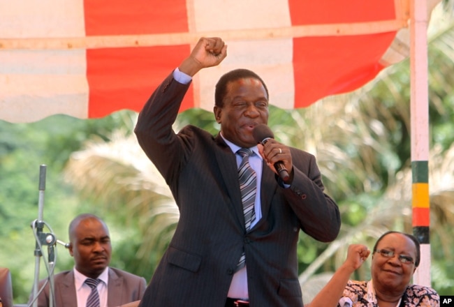 FILE - Then-Zimbabwean Vice President Emmerson Mnangagwa greets party supporters at the ZANU-PF headquarters in Harare, Zimbabwe, Feb, 10, 2016. Mnangagwa's firing by Mugabe precipated the current political crisis in Zimbabwe.