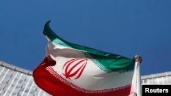 FILE - An Iranian flag flutters in front of U.N. offices in Vienna.