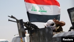 A member of Iraqi security forces gestures near Fallujah, Iraq, May 31, 2016. 