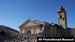 The tower of the Church of the Madonna of the Angels (Madonna degli Angeli) is still standing amidst rubble near Norcia, central Italy, after an earthquake with a preliminary magnitude of 6.6 struck central Italy, Oct. 30, 2016.