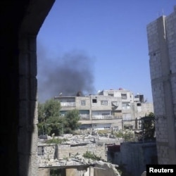 Smoke rises from the suburb of Erbeen in Damascus July 19, 2012.