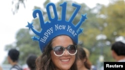 Chilean tourist Paula Aedo ushers in 2017 as she arrives to watch New Year's fireworks in Sydney, Australia, Dec. 31, 2016.