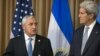 Guatemala’s President Otto Perez Molina, left, and U.S. Secretary of State John Kerry discuss immigration while in Panama City, July 1, 2014.