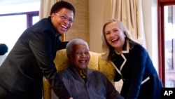Secretary of State Hillary Rodham Clinton meets with former South Africa President Nelson Mandela and his wife Graca Machel at his home in Qunu, South Africa, Aug. 6, 2012.