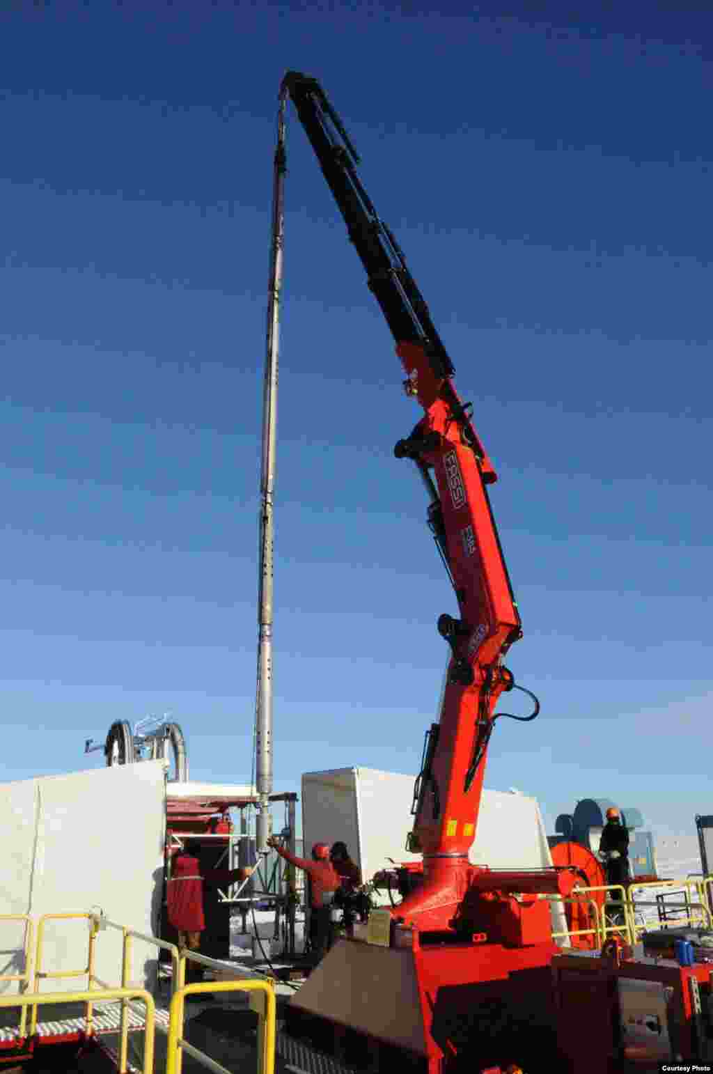 A suite of physical oceanographic instruments is lowered into the borehole.&nbsp; (Reed Scherer/NIU) &nbsp;