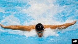 FILE - United States' Michael Phelps swims in the men's 4 X 100-meter medley relay at the Aquatics Center in the Olympic Park during the 2012 Summer Olympics in London.