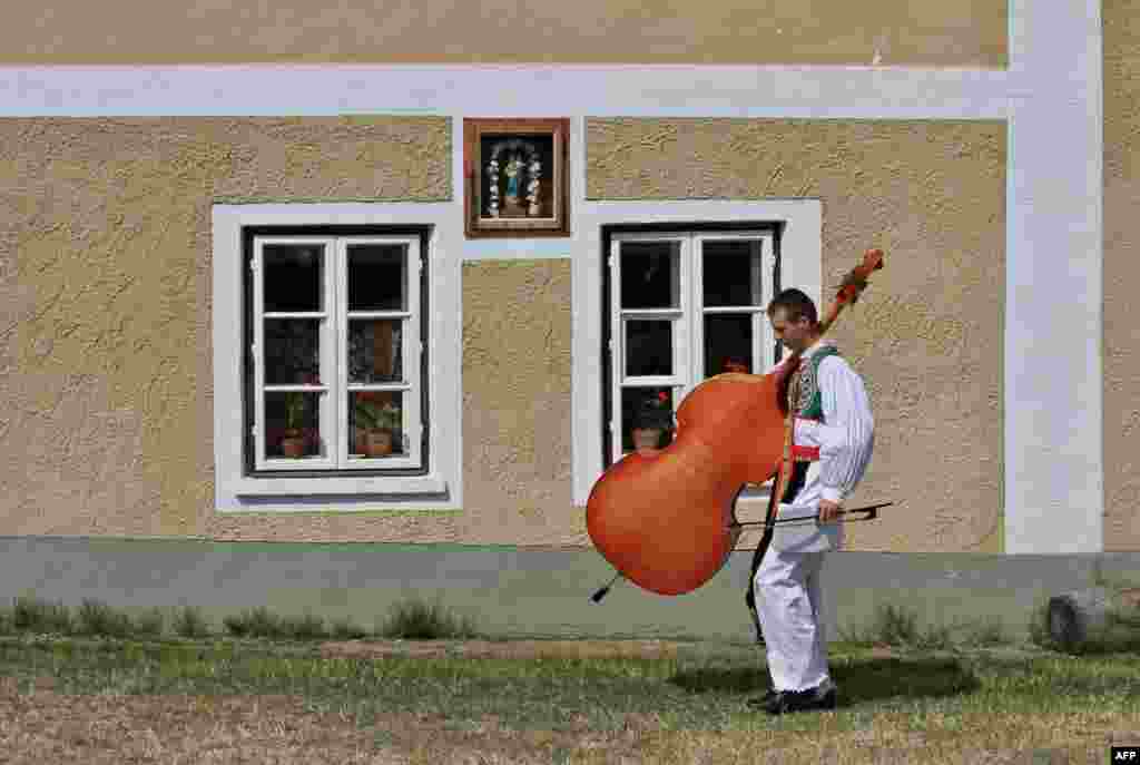 A young man carries his instrument during the oldest folklore festival of Europe in Straznice, south Moravia, 80 km southeast from Brno, Czech Republic.