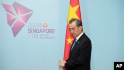 China's Foreign Minister Wang Yi pauses before a bilateral meeting with Philippines' Foreign Affairs Secretary Alan Cayetano on the sidelines of the 51st ASEAN Foreign Ministers Meeting in Singapore, Aug. 2, 2018. 