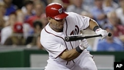 Washington Nationals' Wilson Ramos hitting a sacrifice bunt to drive in teammate Michael Morse for the go-ahead run in the seventh inning against the Chicago Cubs at Nationals Park in Washington, July 6, 2011.