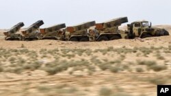 Libyan government army rocket launchers are seen in the desert near the west gate of town Ajdabiyah, March 17, 2011