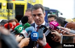 Spain's Prime Minister Pedro Sanchez speaks to media as heavy rain and flash floods hit Sant Llorenc de Cardassar on the island of Mallorca, Oct. 10, 2018.