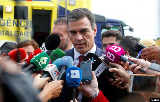 Spain's Prime Minister Pedro Sanchez speaks to media as heavy rain and flash floods hit Sant Llorenc de Cardassar on the island of Mallorca, Oct. 10, 2018.
