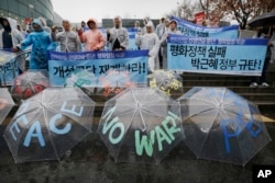 South Korean protesters shout slogans during a rally criticizing U.N. sanction on North Korea and upcoming joint military exercises between the U.S. and South Korea in Seoul, South Korea, March 5, 2016.