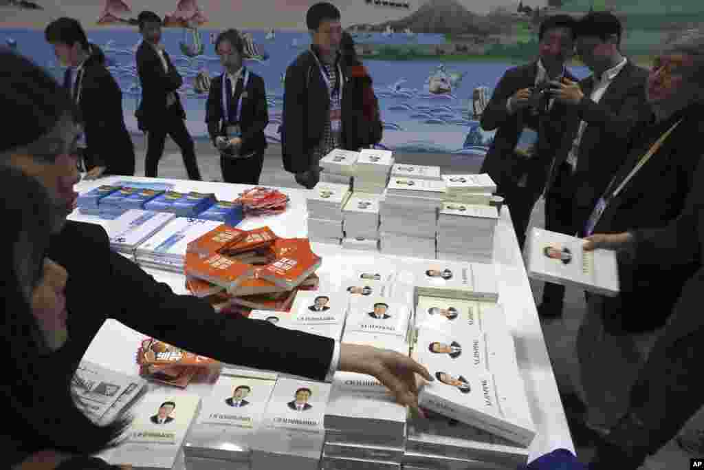 Attendees get copies of a book on the governance of Chinese President Xi Jinping at the media center for the Second Belt and Road Forum, in Beijing, China.