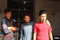 Young men in this grocery store say they have applied for permits to leave the camp but have been denied, even though their homes are empty only kilometers away, May 29, 2018, Hassan Sham, Iraqi Kurdistan. (H. Murdock/VOA)
