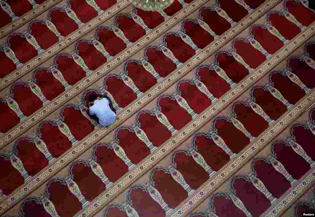 A man prays at a mosque during the holy fasting month of Ramadan in Jakarta, Indonesia.