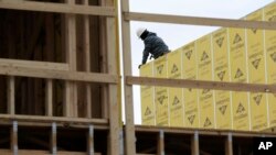 FILE - Work continues on a new development in Fair Lawn, New Jersey, Feb. 26, 2018. On March 9, the Labor Department reported that U.S. employers added 313,000 jobs in February.