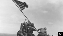 FILE - U.S. Marines raise the American flag atop Mount Suribachi, Iwo Jima, Japan, Feb. 23, 1945. The Marines Corps said Thursday that Private First Class Harold Schultz of Detroit was in the photo and that Navy Pharmacist's Mate 2nd Class John Bradley wasn't.