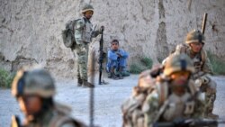 Soldiers from 1st Battalion the Royal Gurkha Rifles patrol through a village in Nahr e Saraj,