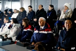 FILE - Vice President Mike Pence, second from bottom right, sits between second lady Karen Pence, third from from bottom left, and Japanese Prime Minister Shinzo Abe at the opening ceremony of the 2018 Winter Olympics in Pyeongchang, South Korea, Feb. 9, 2018.