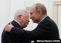 RUSSIA -- Russian President Vladimir Putin embraces Palestinian President Mahmoud Abbas during a meeting at the Kremlin in Moscow, February 12, 2018.