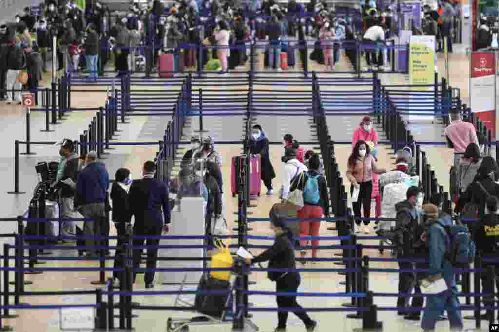 Passengers check-in at the Jorge Chavez International Airport in Callao, Peru, Monday, Oct. 5, 2020. After international flights were halted for more than six months amid the COVID-19 pandemic, Peru's largest airport resumed flights on Monday to Colombia, Ecuador, Panama, Paraguay, Uruguay, Bolivia, and Chile. (AP Photo/Martin Mejia)