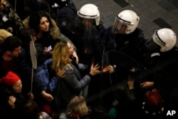 A protester reacts as Turkish police block Istiklal, the main shopping street, in Istanbul, during International Women's Day, March 8, 2019.
