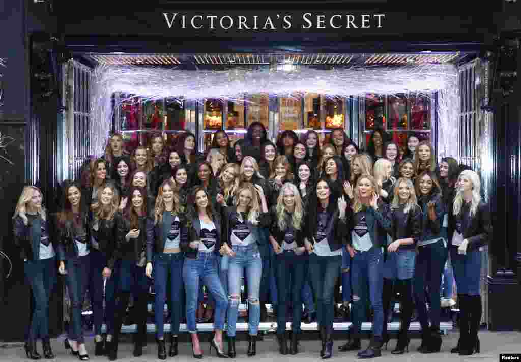 Models pose for a group photograph outside the Victoria&#39;s Secret shop on New Bond Street in central London.