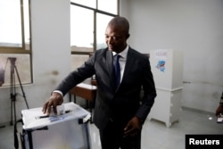 FILE - Emmanuel Ramazani Shadary, former Congolese Interior minister and presidential candidate, casts his vote at a polling station in Kinshasa, Democratic Republic of Congo, Dec. 30, 2018.