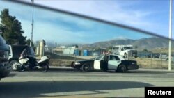 Police vehicles are seen on the road near Highland High School, in Palmdale, California, May 11, 2018, in this picture grab obtained from social media video. 