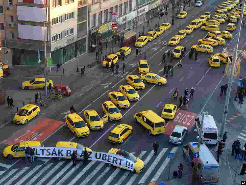 Taxis drivers block traffic as they protest, demanding a ban on Uber in downtown Budapest, Hungary.