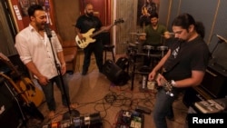 FILE - Guitarist Khurram Waqar, right; vocalist Umair Jaswal, left; bass guitarist Rahail Siddiqui; and drummer Asfendyar Ahmad of the rock band Qayaas, shown rehearsing last April in Islamabad,say the security situation has hampered Pakistan's music scene.