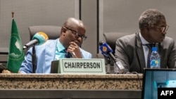 Permanent Representative of Sierra Leone and Chairperson of the African Union Peace and Security Council Patrick Kapuwa (L) speaks during a press briefing regarding the situation of Sudan at the African Union, in Addis Ababa, on June 6, 2019.